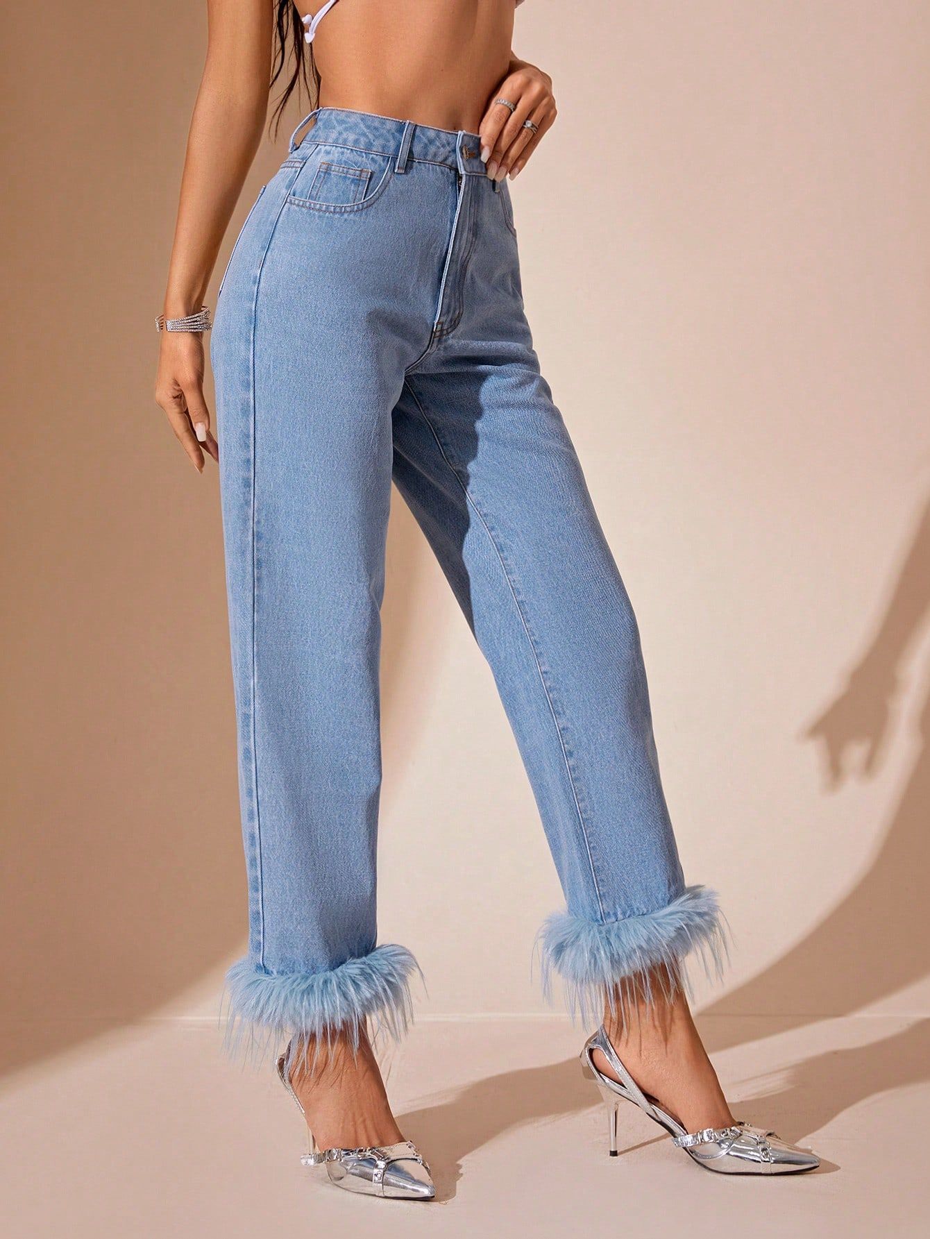 Light-wash blue denim jeans with furry stitching straight faux fur trim at ankles