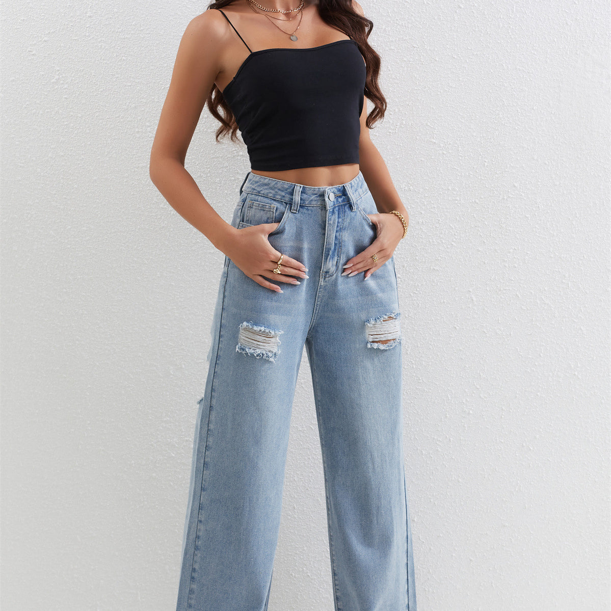 Light blue distressed wide-leg jeans with a black crop top for trendy fashion ملابس