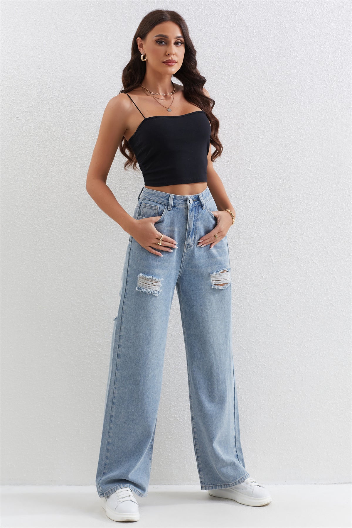 Light blue distressed wide-leg jeans with a black crop top for trendy fashion ملابس