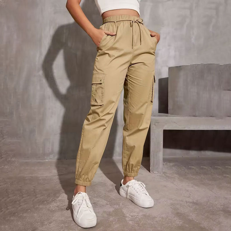 Khaki cargo jogger pants with elastic waist paired with white sneakers for casual fashion ملابس