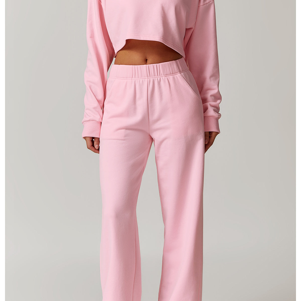 Pink crop top and sweatpants outfit featuring a long sleeve sports top for fashion enthusiasts