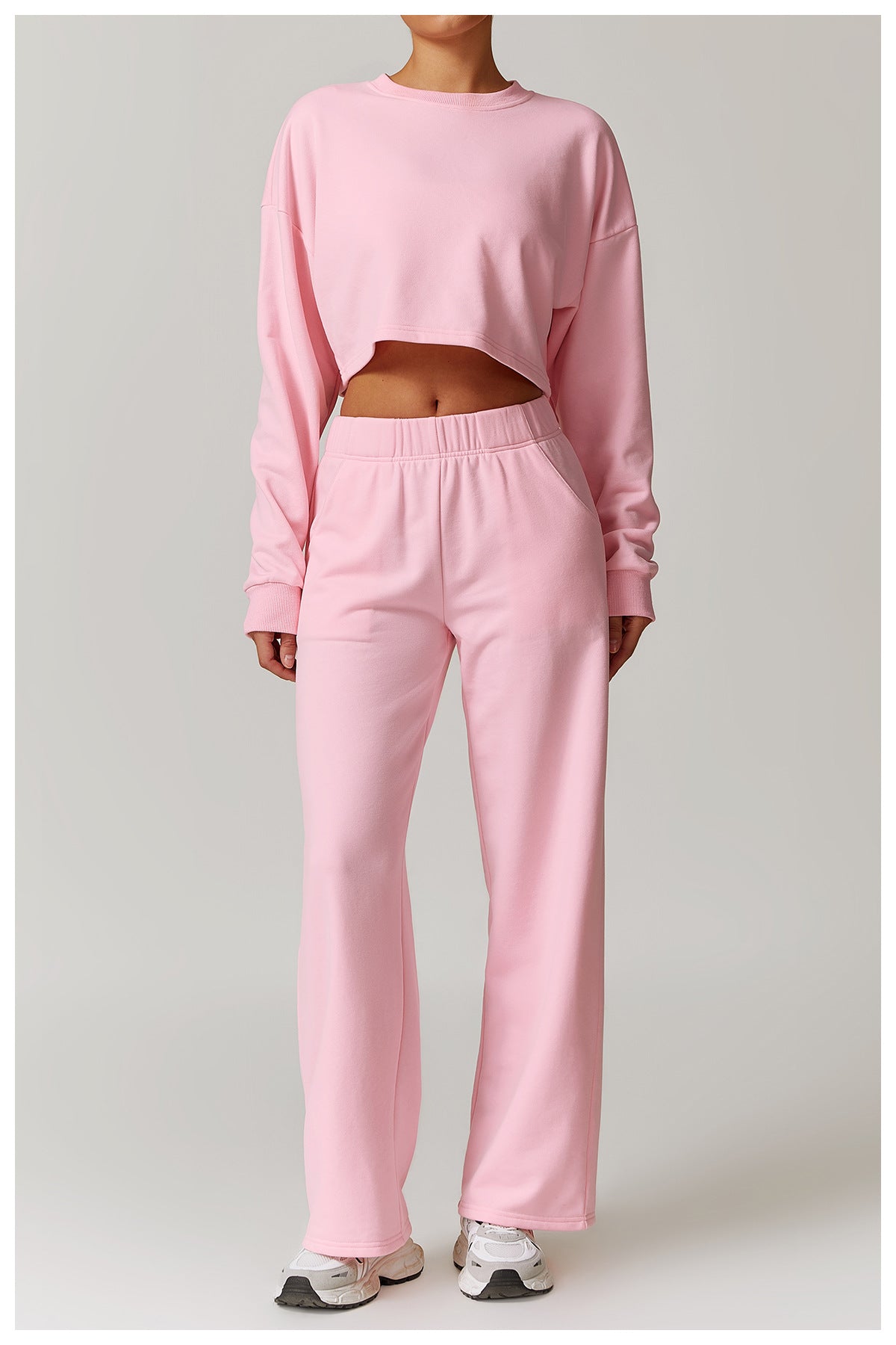 Pink crop top and sweatpants outfit featuring a long sleeve sports top for fashion enthusiasts