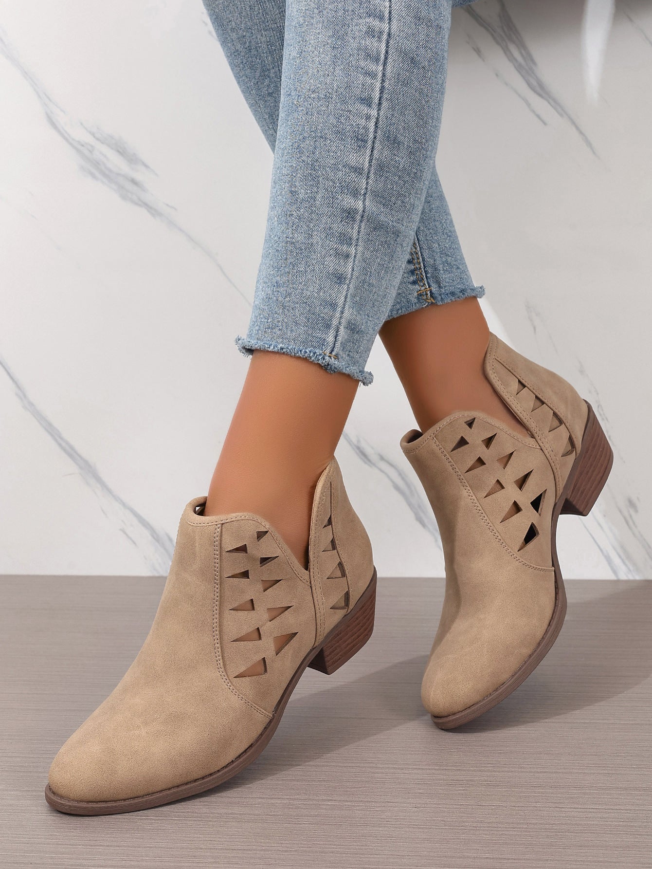Beige suede Daily Ankle Boots featuring decorative side cutouts and low stacked heels