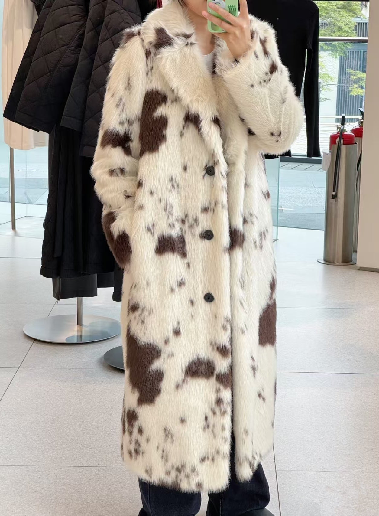 Cozy faux fur long coat with cow print, large buttons, and high collar