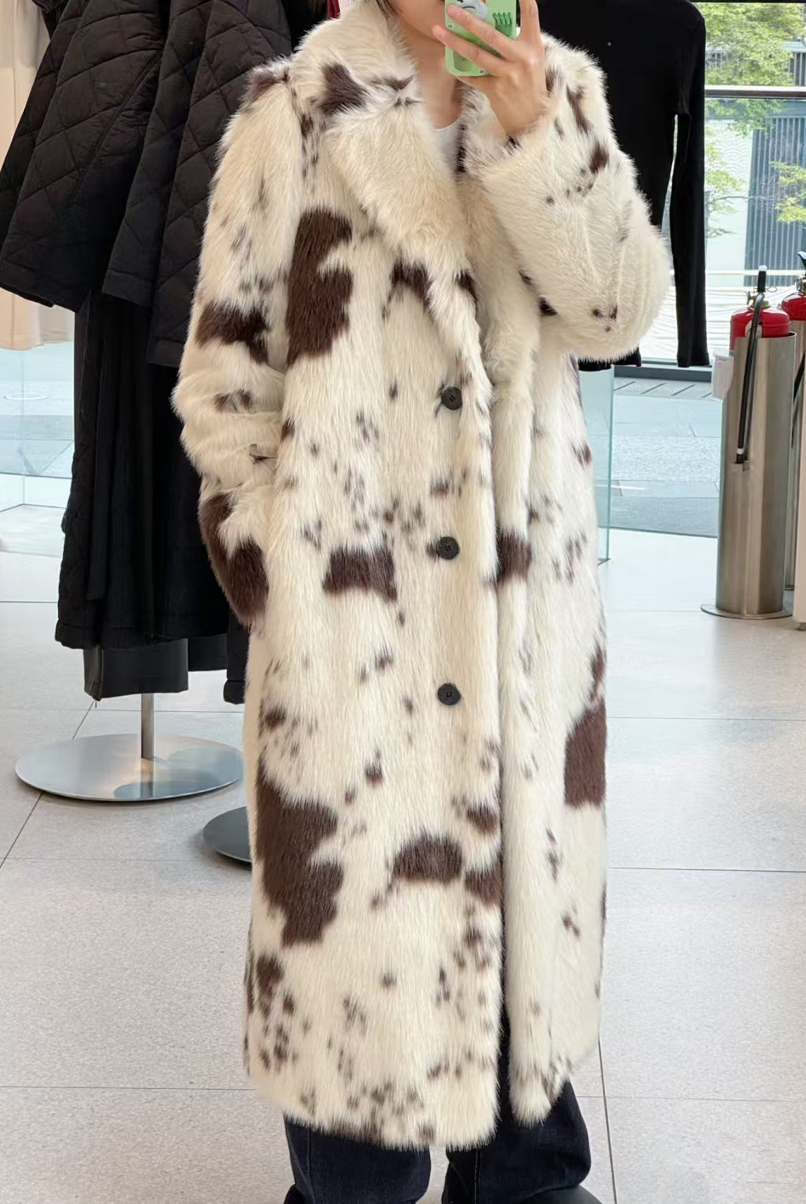 Cozy faux fur long coat with cow print, large buttons, and high collar