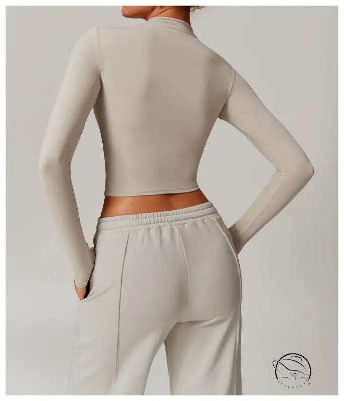 Quick drying fitness sports outerwear: beige cropped top and sweatpants rear view