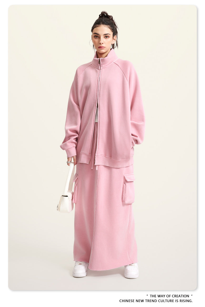Pink fleece two-piece outfit featuring a zip-up jacket and matching maxi skirt for winter fashion