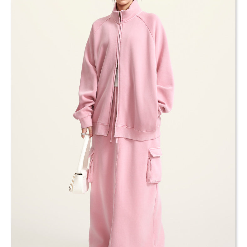 Pink fleece two-piece outfit featuring a zip-up jacket and matching maxi skirt for winter fashion