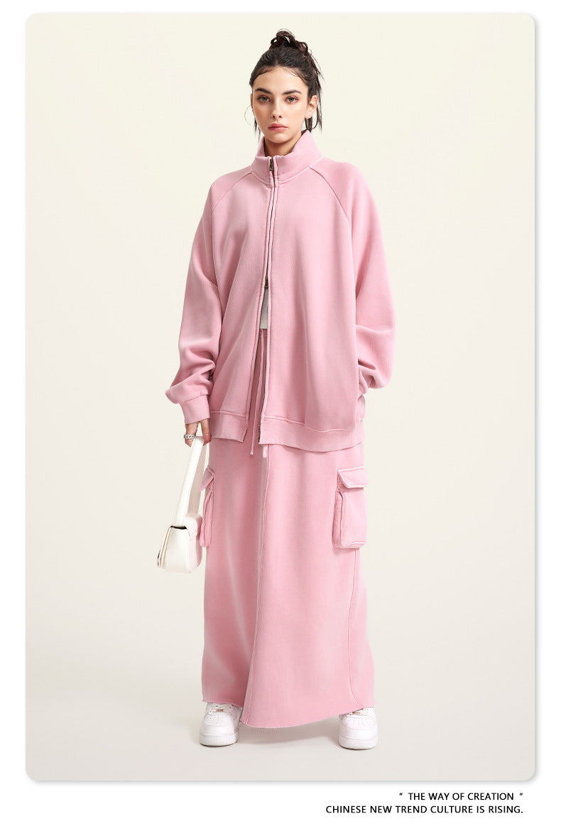 Pink fleece two-piece outfit featuring a zip-up jacket and matching maxi skirt for winter fashion