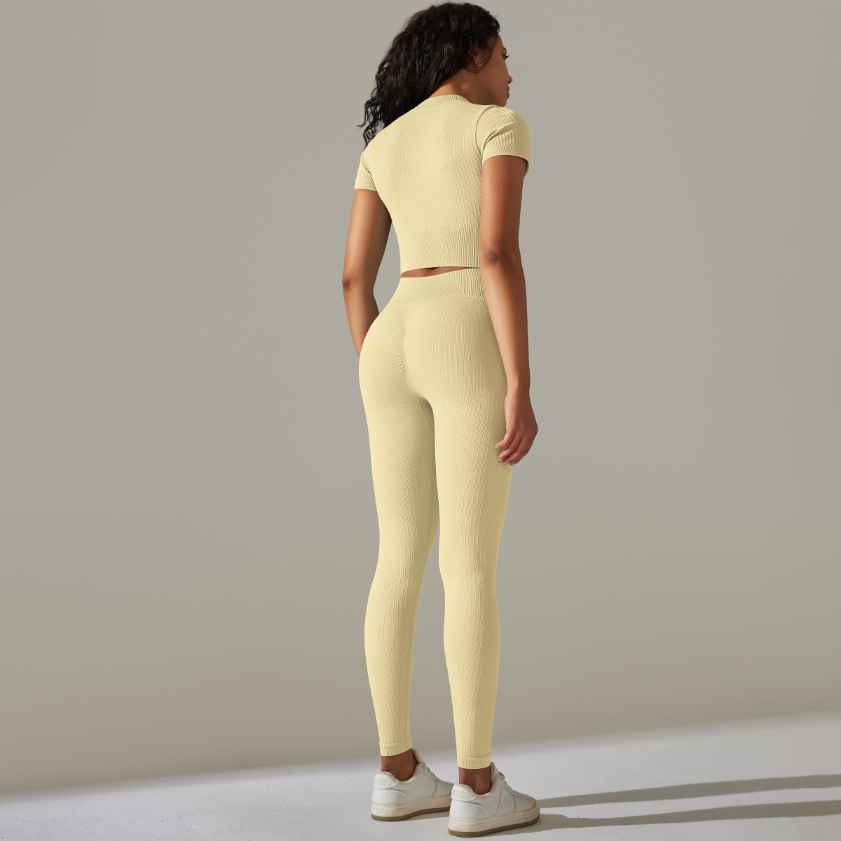 Woman wearing seamless knitted peach hip high waist yoga set for activewear and fitness