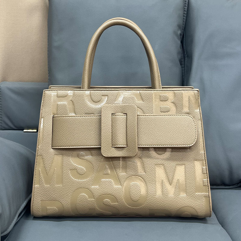 Gold-toned structured handbag with embossed lettering, a stylish fashion accessory