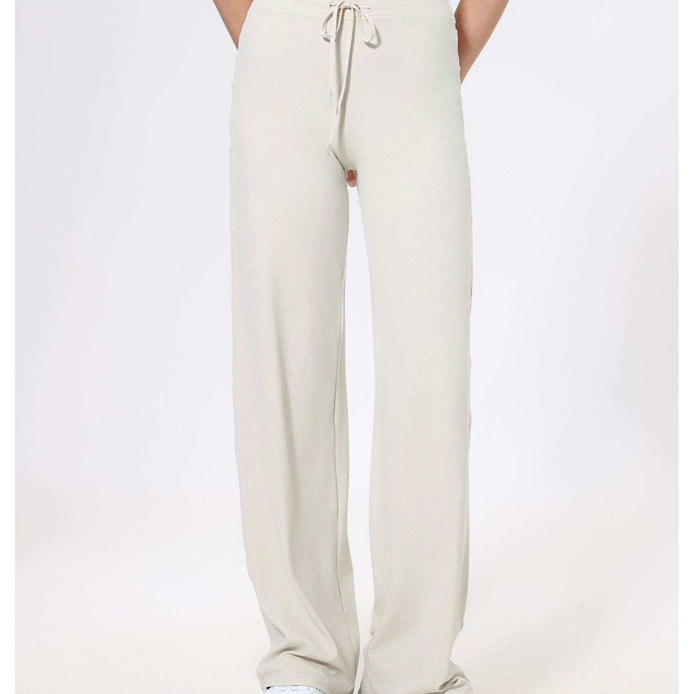 Cream-colored drawstring sweatpants with straight-leg styling for fashionable comfort in ملابس