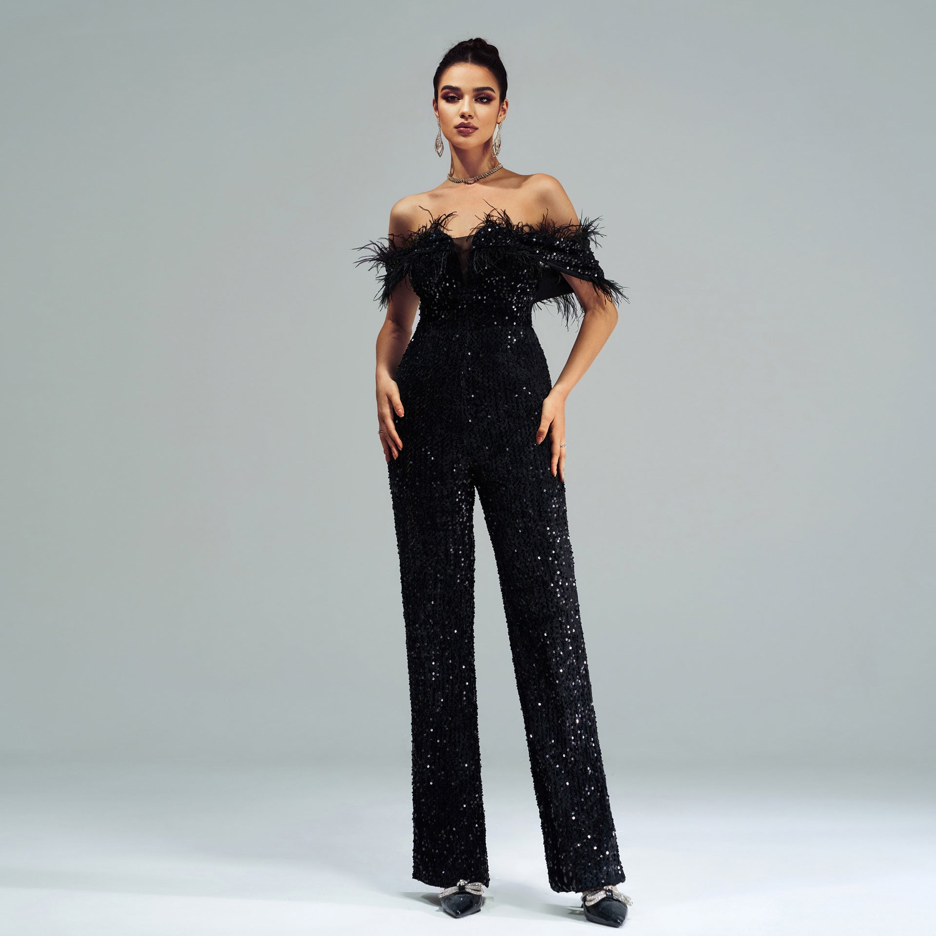 Elegant black sequined jumpsuit with feather trim showcasing high-end fashion and ملابس style