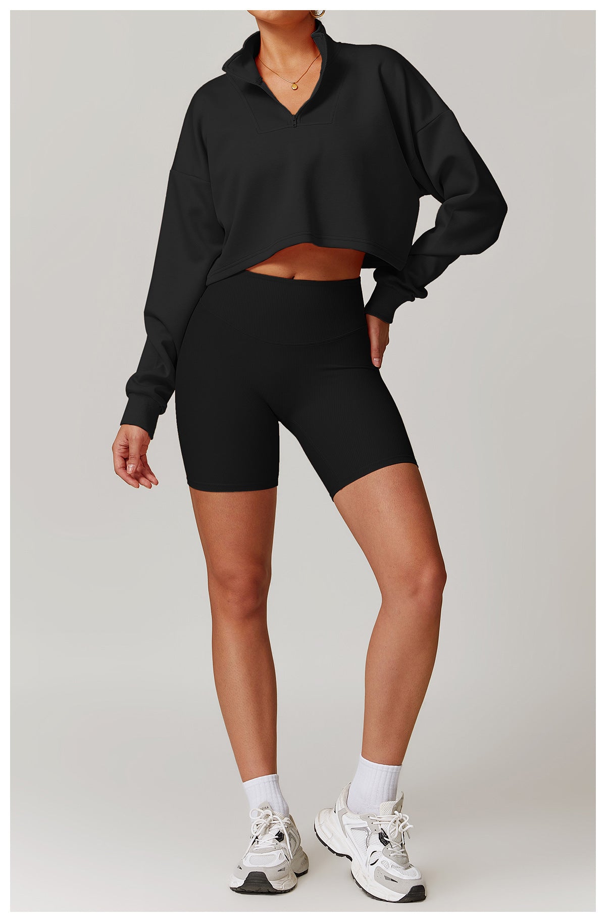 Black cropped sweatshirt and biker shorts athletic set for trendy winter sports fashion ملابس