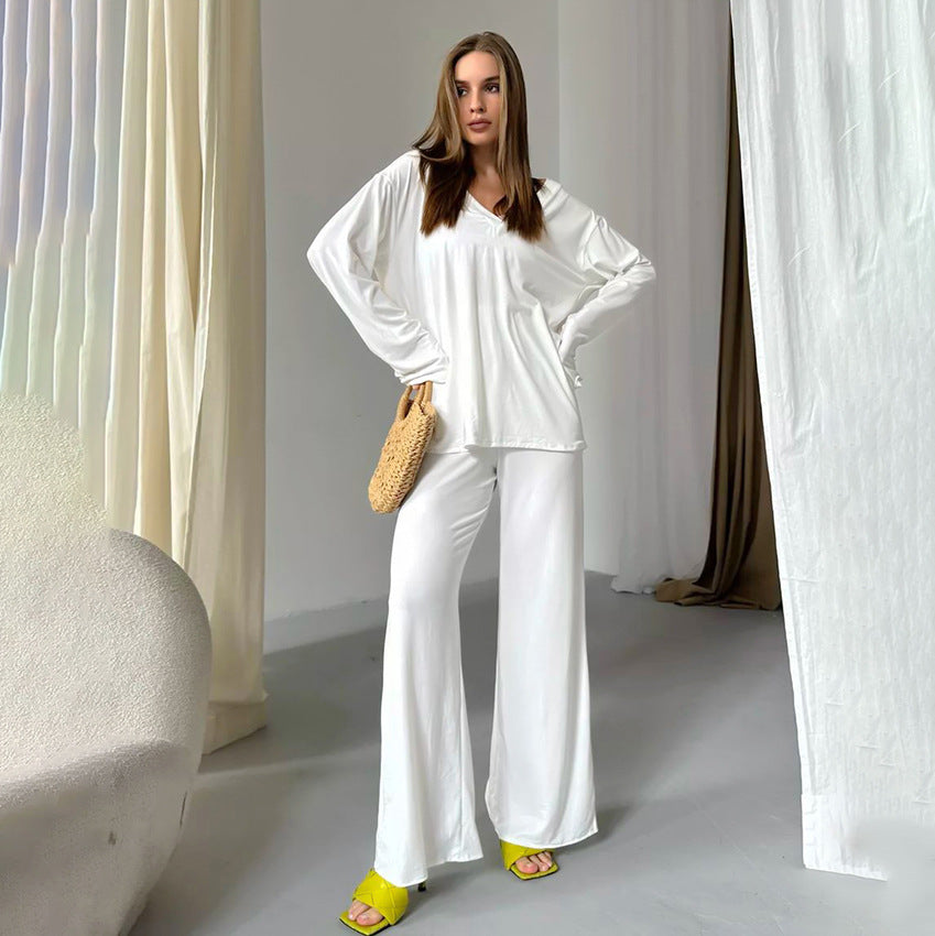 Woman in comfortable knitted pajamas with white long-sleeve top, wide-leg pants, and yellow heels