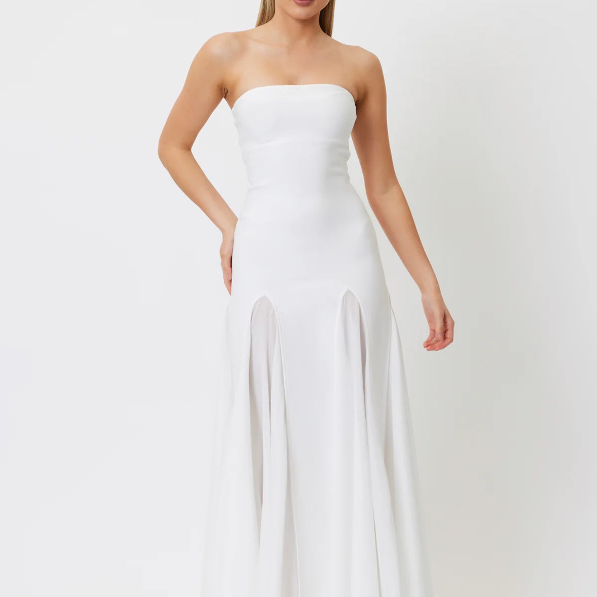 Strapless white floor-length gown with fitted bodice and flowing skirt panels for fashion