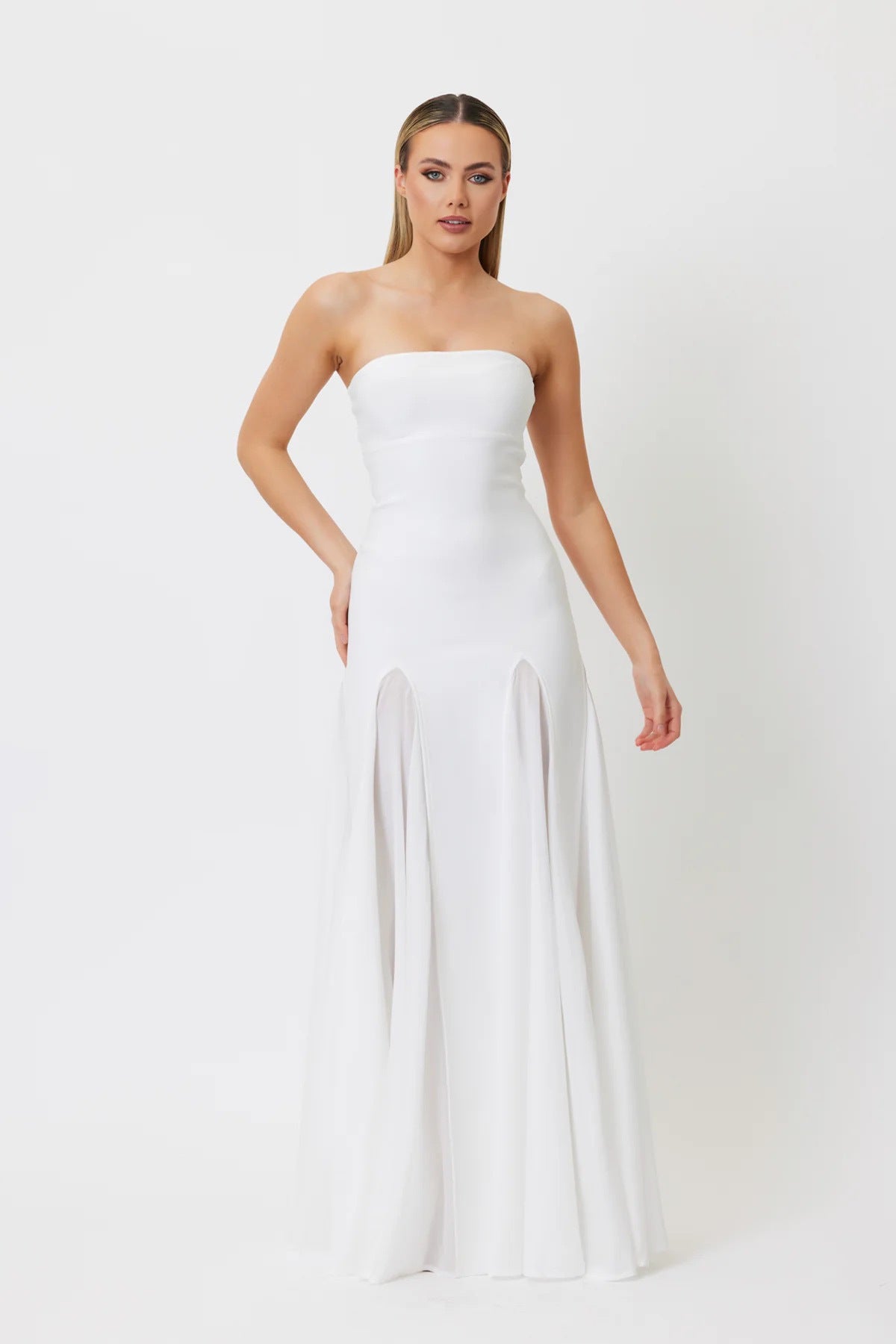 Strapless white floor-length gown with fitted bodice and flowing skirt panels for fashion