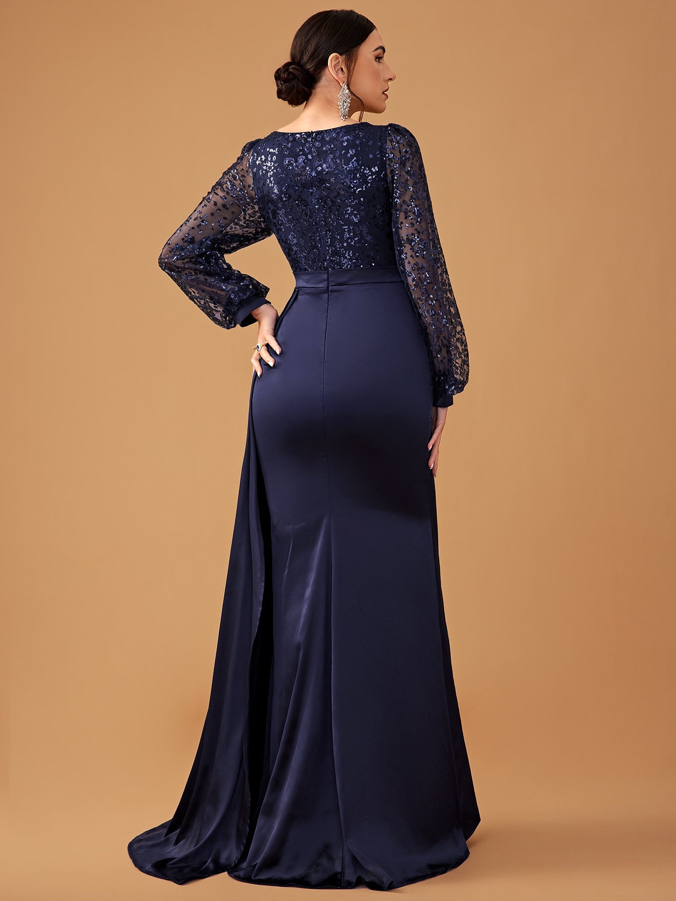 Navy blue sequined long-sleeved gown showcasing elegant evening fashion ملابس