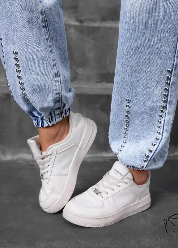 Light-wash match beaded straight jeans with silver studs and white sneakers