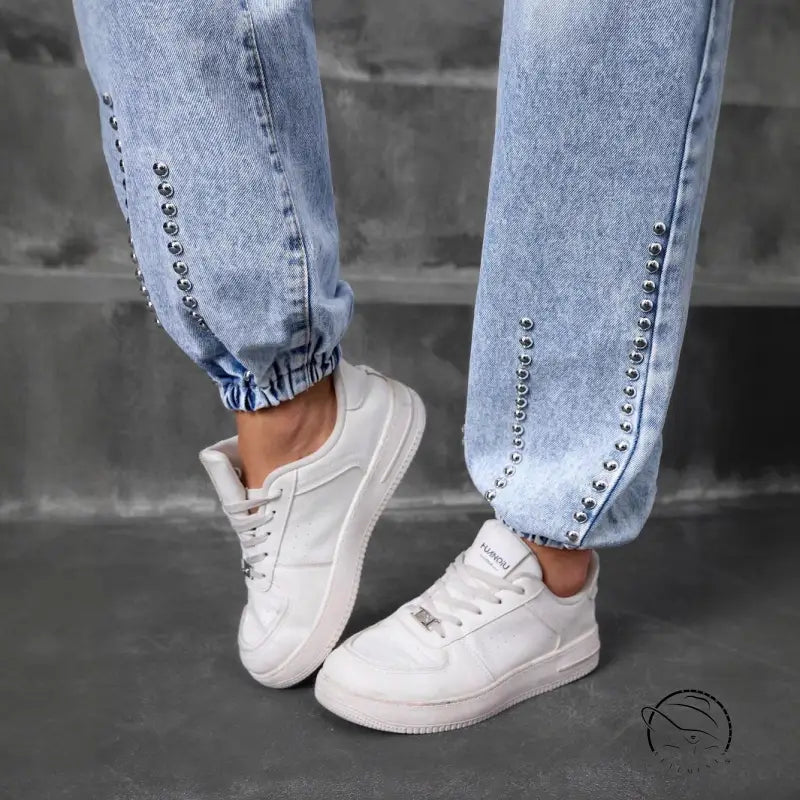 Light-wash match beaded straight jeans with silver studs and white sneakers