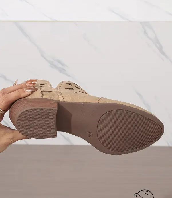 Beige leather oxford daily ankle boot with brown sole held sideways