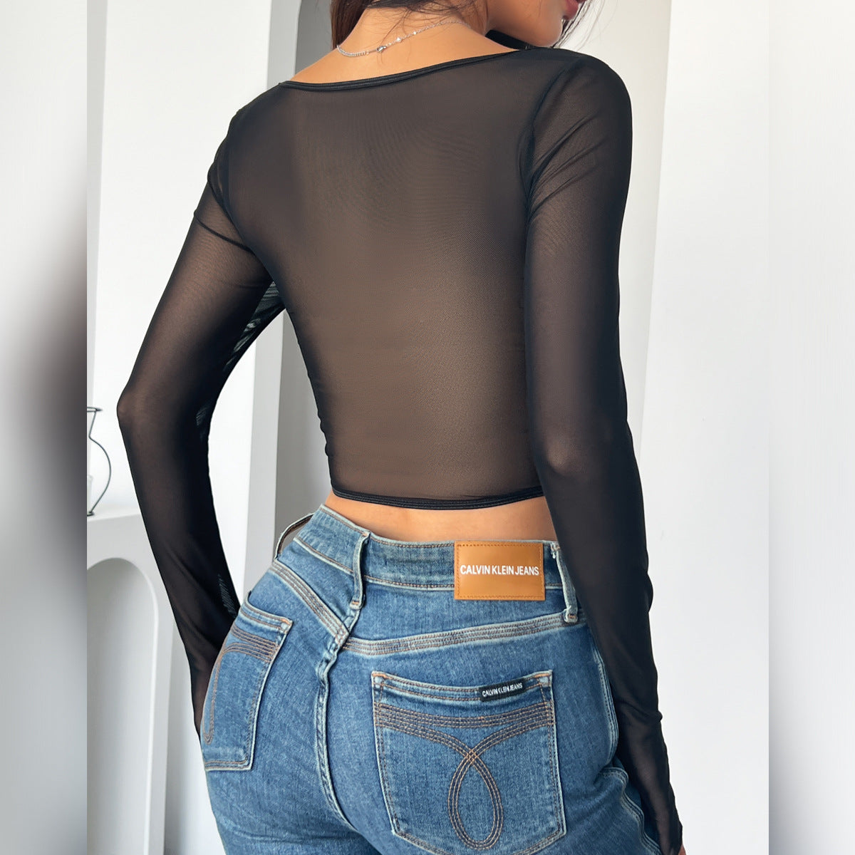 Sheer black long-sleeved top made of faux leather from Langry Fashion for stylish outfits