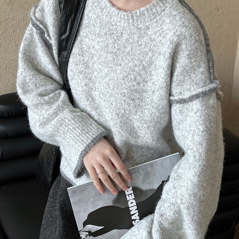 Cozy light gray knit sweater with ribbed neckline, perfect for casual fashion ملابس