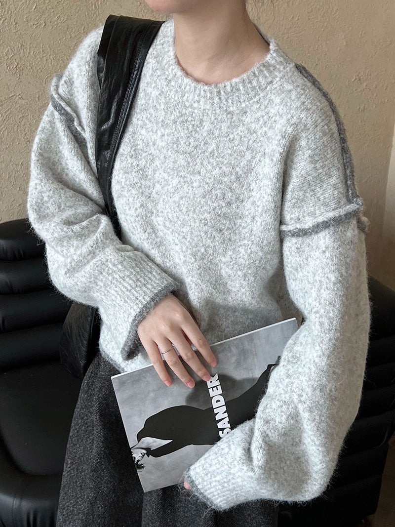 Cozy light gray knit sweater with ribbed neckline, perfect for casual fashion ملابس