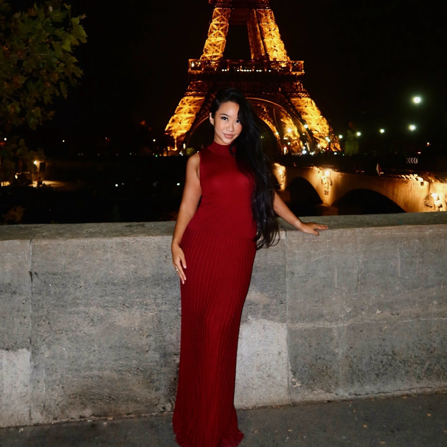A person elegantly wearing a long red maxi dress from the Enchanting Knitted collection
