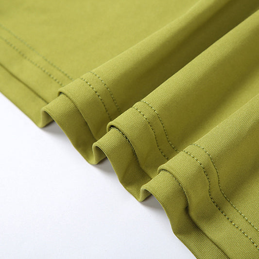 Wrinkled green fabric with stitched hem of PLEATED SLIM HIP DRESS showcasing sexy pleated slim style