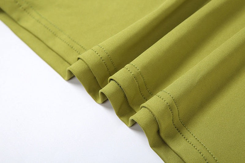 Wrinkled green fabric with stitched hem of PLEATED SLIM HIP DRESS showcasing sexy pleated slim style