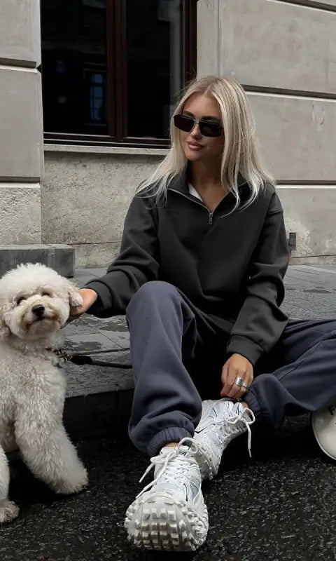 Woman in gray half zipper autumn winter fleece lined sweatsuit with white sneakers