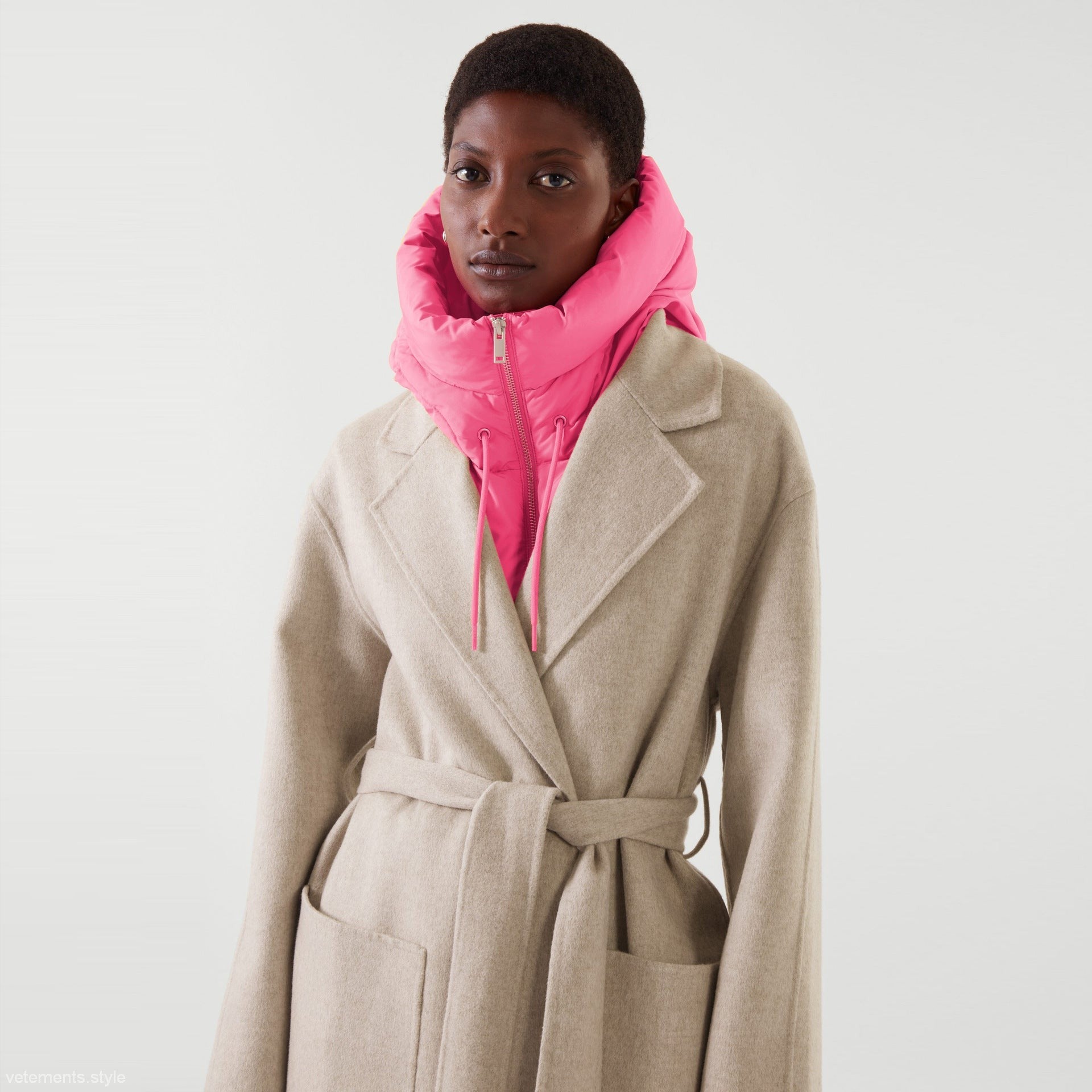 Woman in beige belted coat with rose red puffer hood from Hooded Accessories