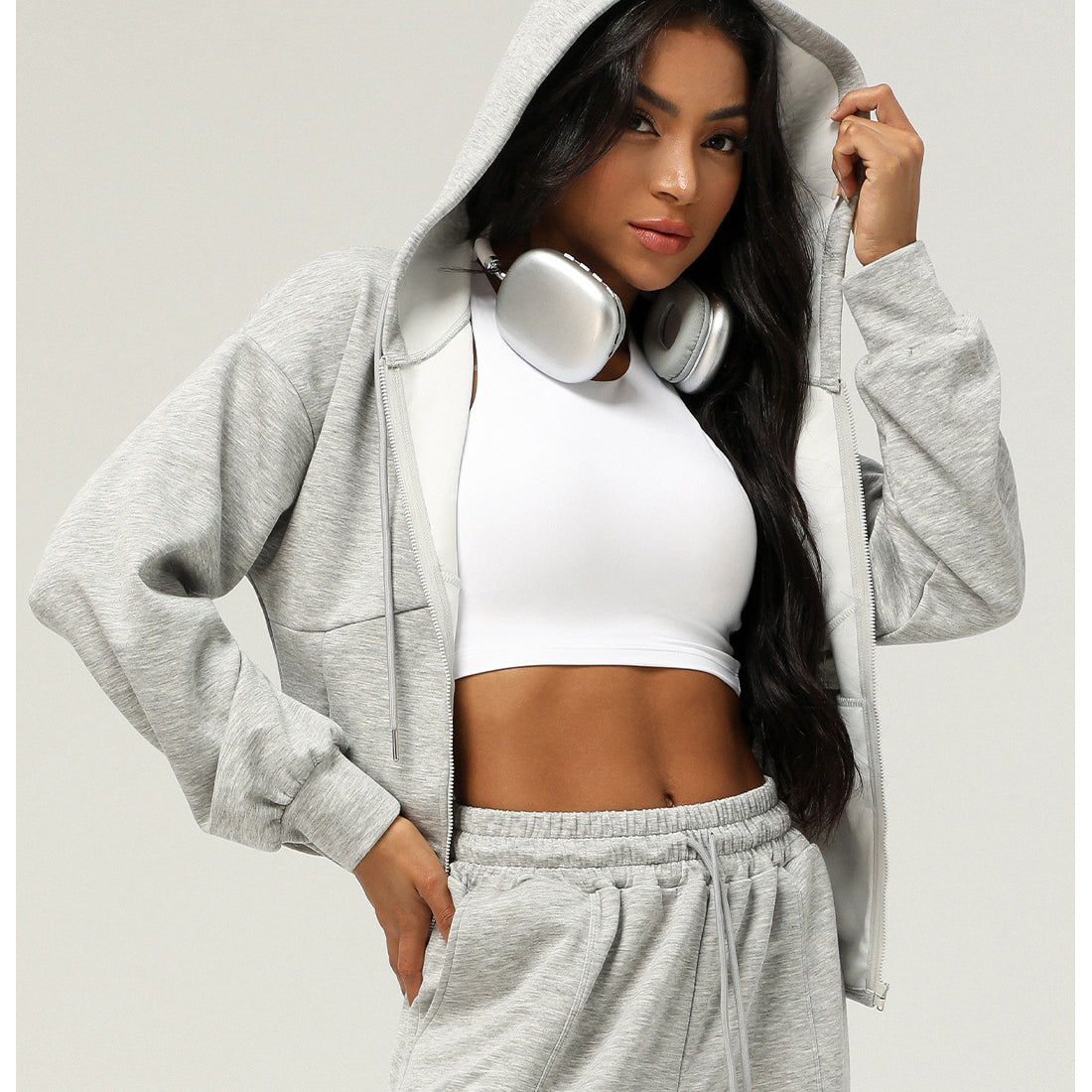 Woman in gray hooded tracksuit with headphones showcasing trendy Langry fashion ملابس