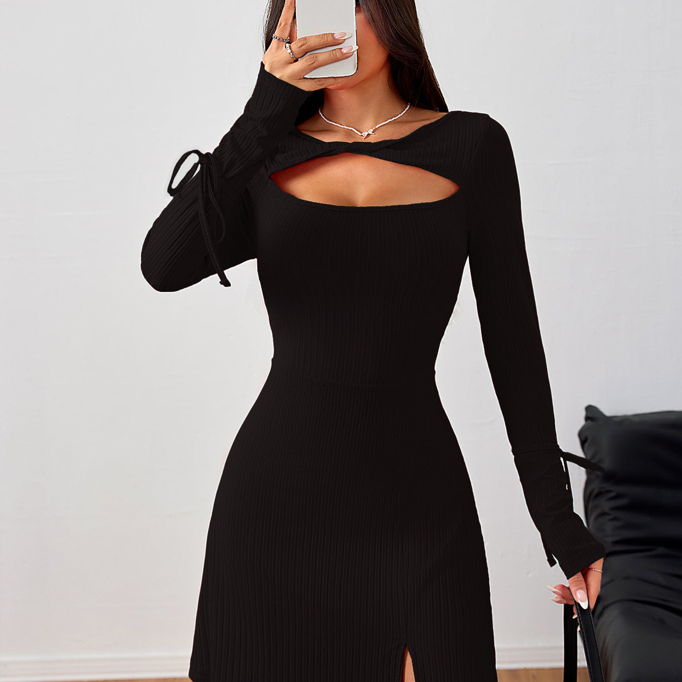 Black long-sleeved mini dress with cutout detail and side slit, perfect for trendy fashion ملابس