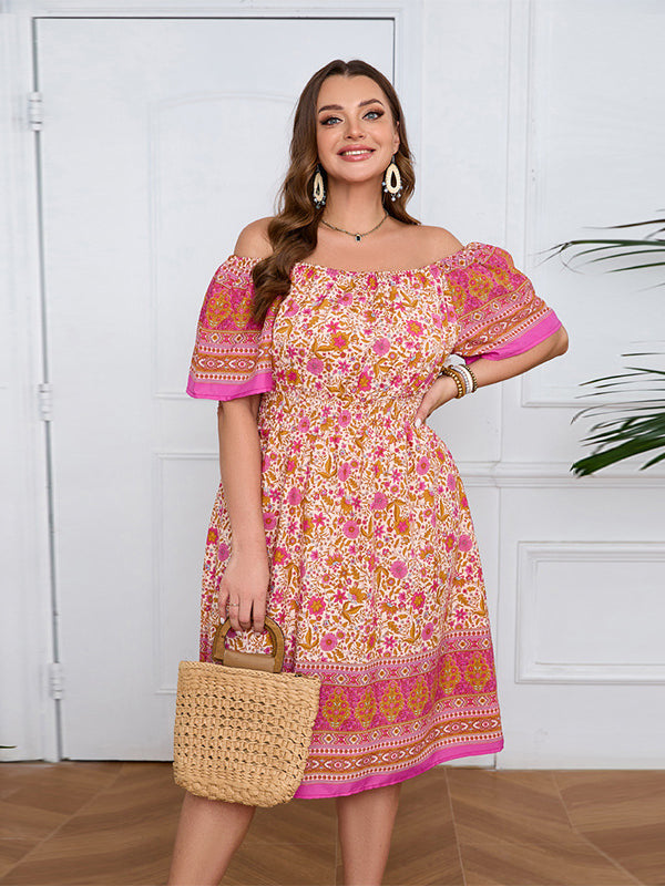 Smiling woman in an elegant bohemian dress with floral print and straw handbag