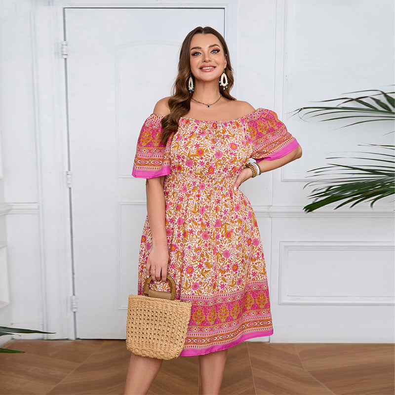 Smiling woman in an elegant bohemian dress with floral print and straw handbag