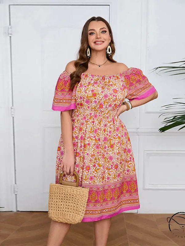 Smiling woman in elegant bohemian dress with floral print and straw bag