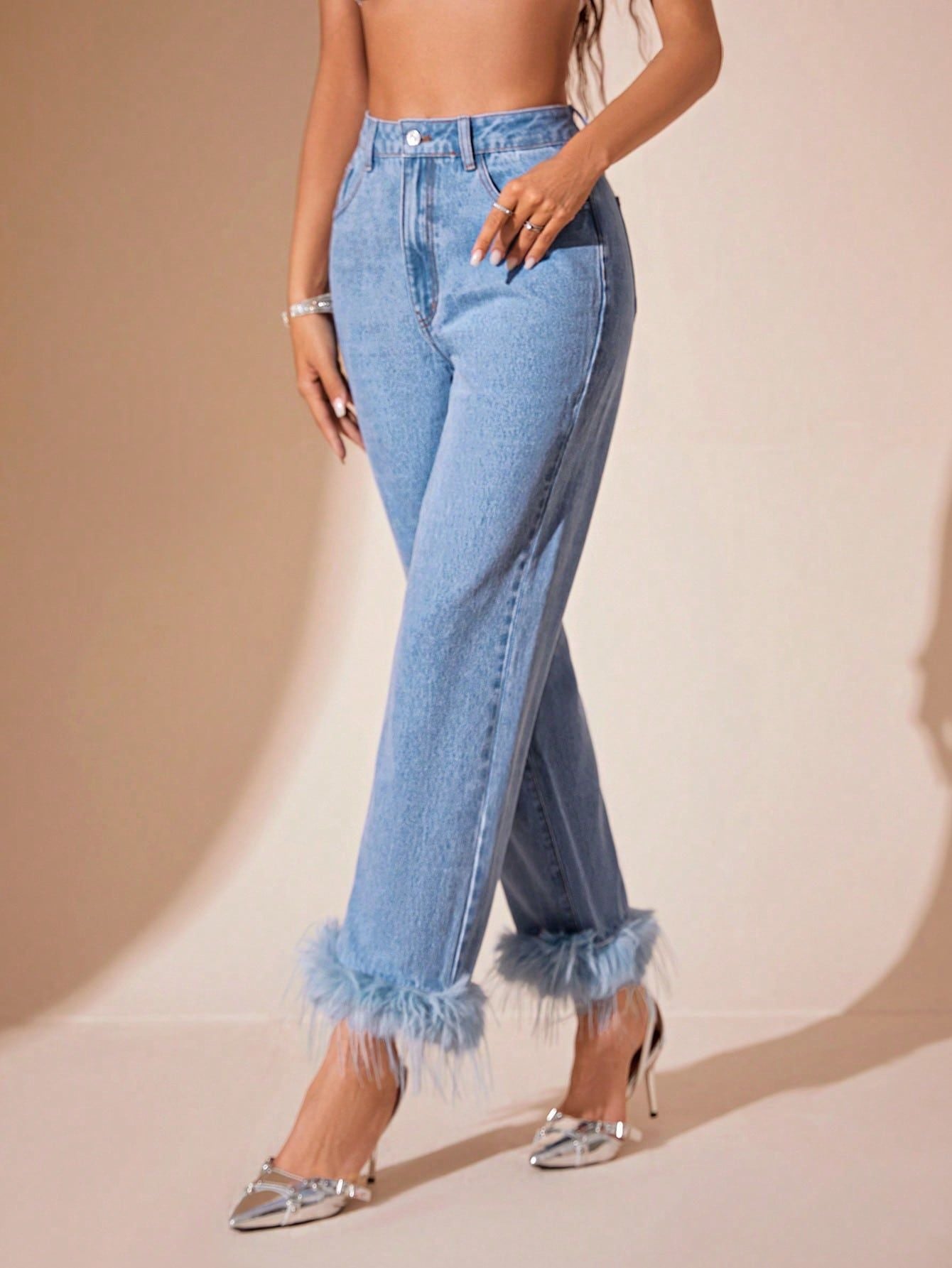 Light wash blue denim jeans with feathered cuffs featuring furry stitching and a straight fit
