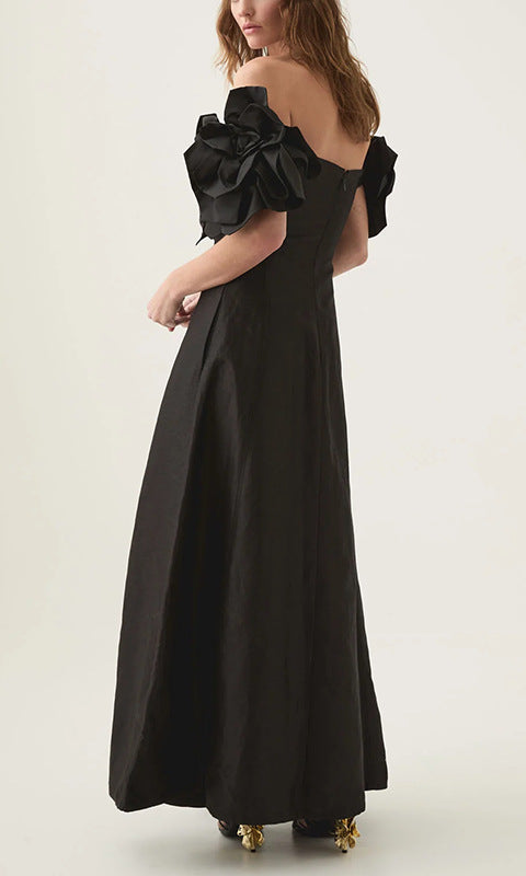 Black off-the-shoulder maxi dress with floral accents, perfect for elegant fashion styling