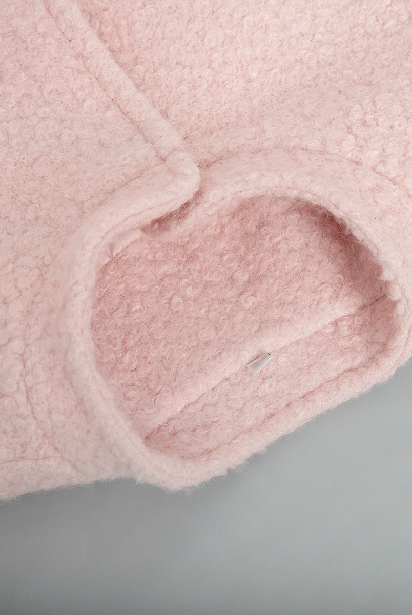 Close-up of pink fuzzy fabric sleeve on Pink Short Furry Coat for stylish cold-weather wear