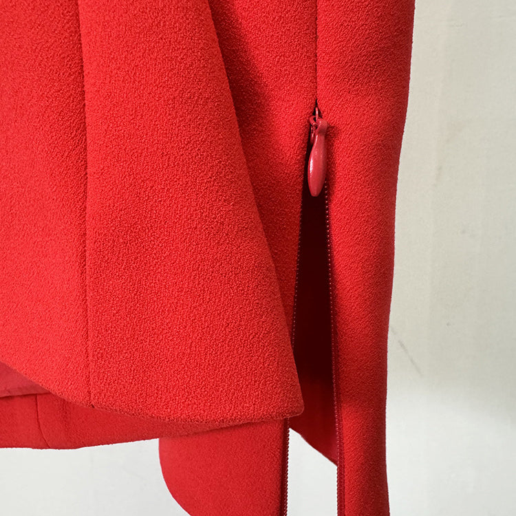 Lower portion of a red dress with side slit and zipper, perfect for elegant fashion styles