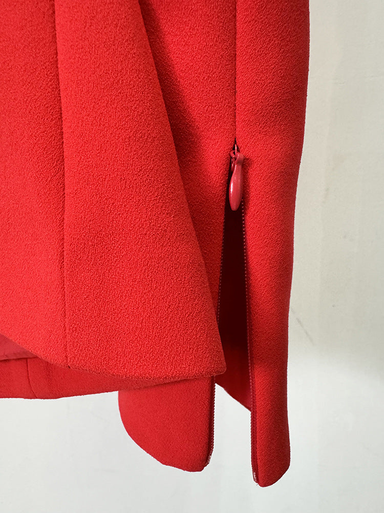 Lower portion of a red dress with side slit and zipper, perfect for elegant fashion styles