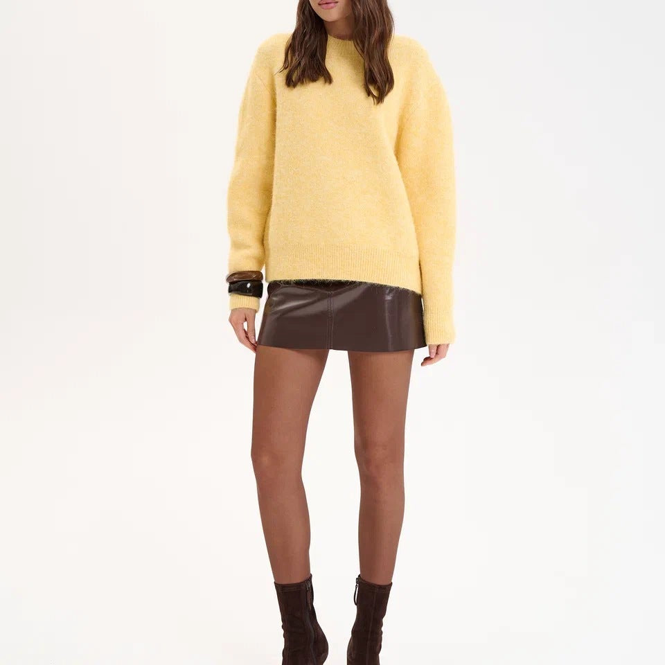 Yellow wool alpaca oversized sweater with black sunglasses and brown leather boots