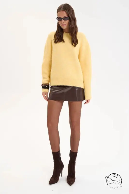 Yellow wool alpaca winter loose long sweater with black sunglasses and brown leather boots