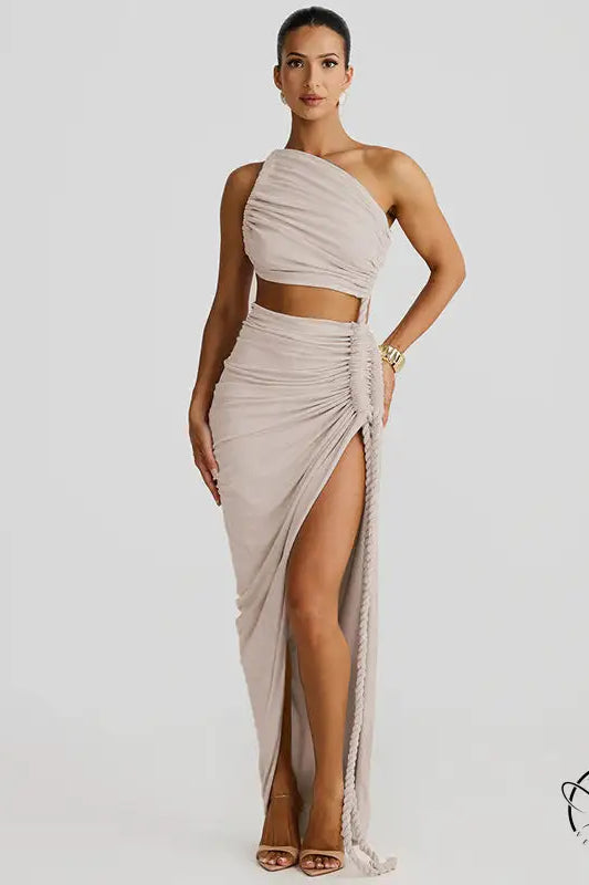 Stunning cutout lace pleated dress with beige one-shoulder crop top and high-slit skirt
