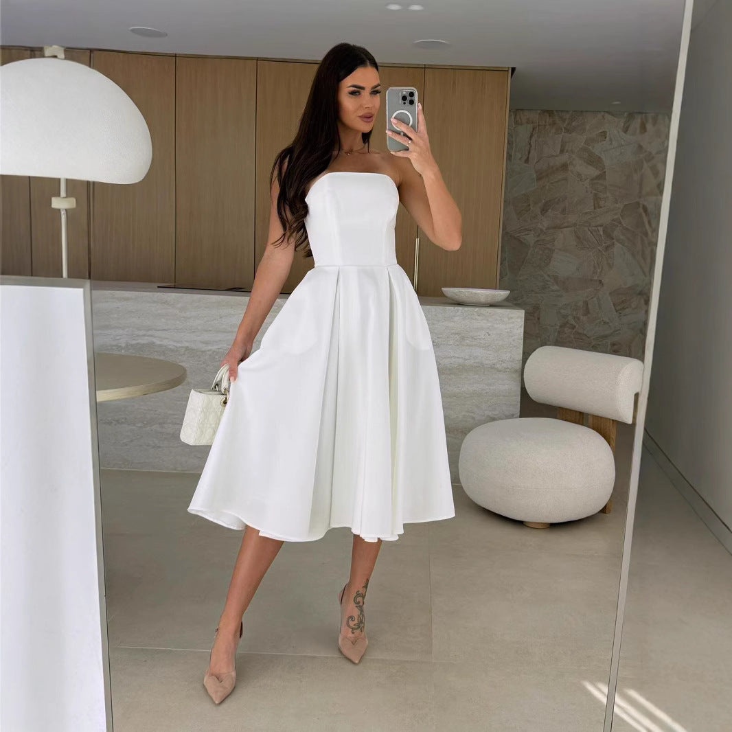 Woman in a white strapless dress, showcasing the Gorgeous Midi Dress fashion style
