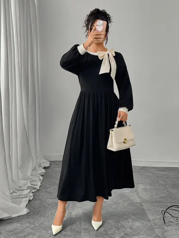 Winter retro slim black dress with long sleeves, white accents, and bow detail