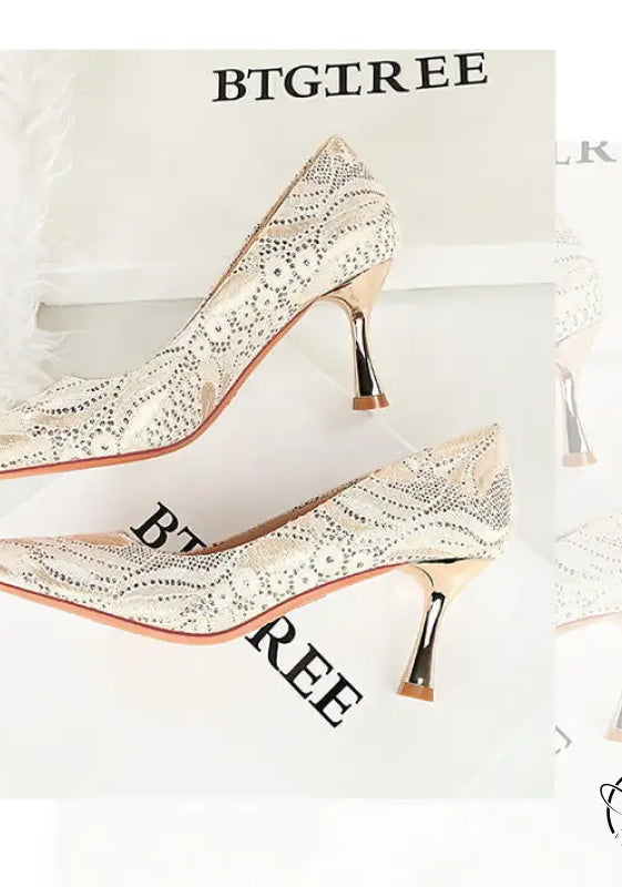 Elegant white snakeskin high heel with gold accents and tassel, langry fashion