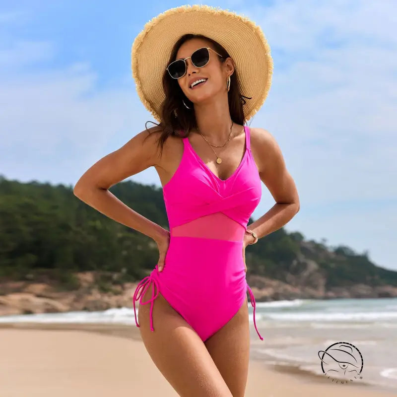 Stunning mesh swimsuit in hot pink with cutouts, side ties and V-neckline